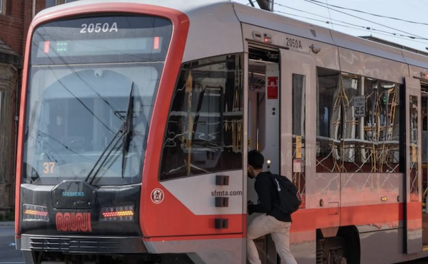 Person boards a streetcar.