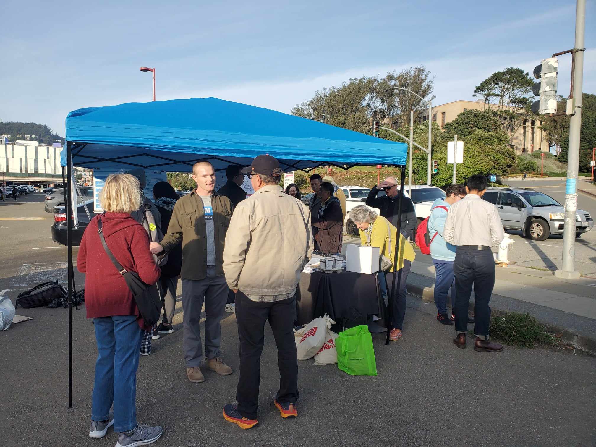 People gathered under a canopy