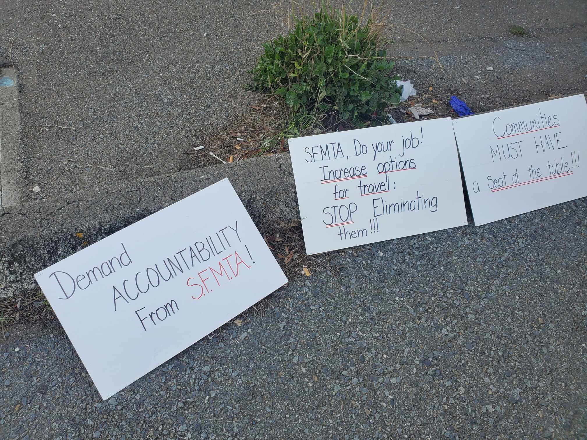 Three signs rest in a gutter