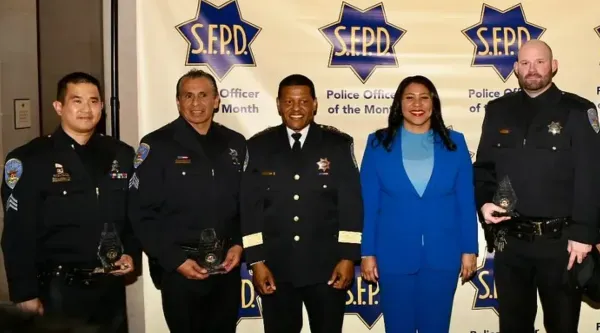 Cops with mayor posing for photo.