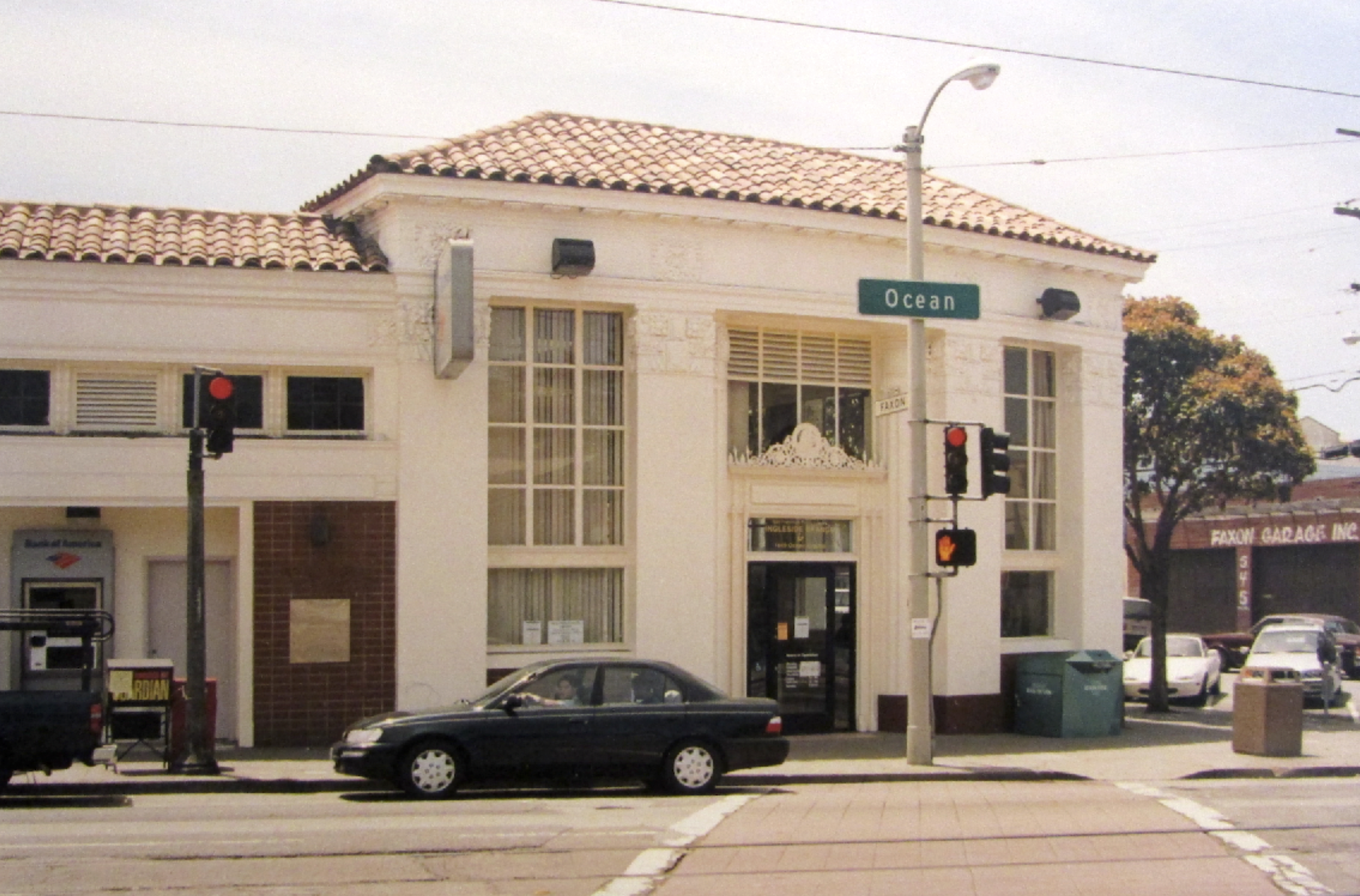 An ornate building stands with a car parking in front. 