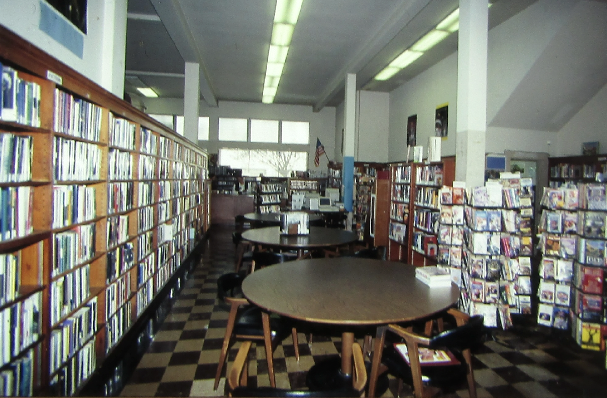 Bookshelves and tables inside a library.