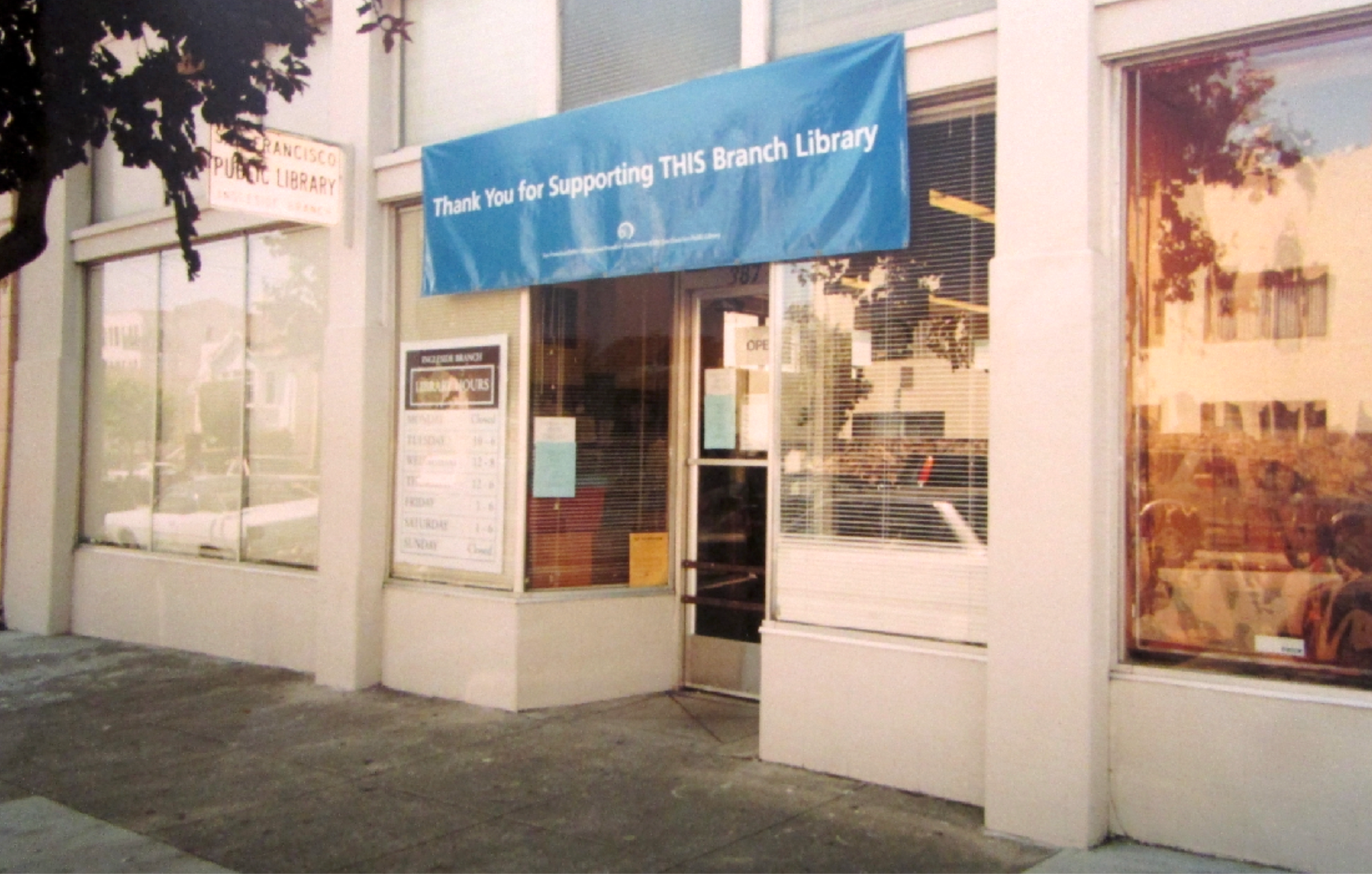 Building facade with a sign that reads "Thank You for Supporting THIS Branch Library."