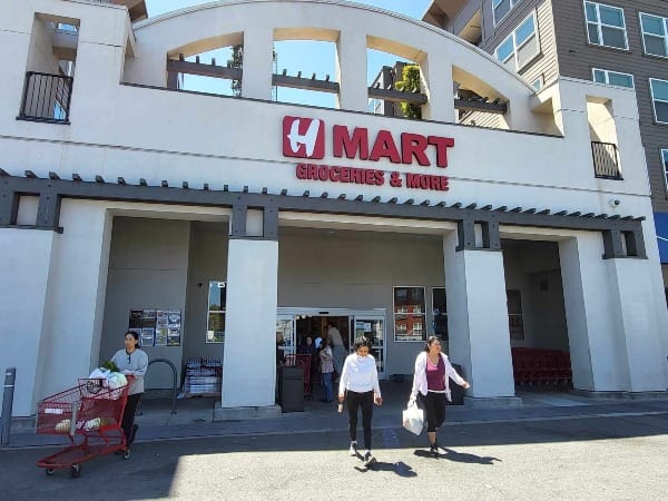 People leaving a supermarket.
