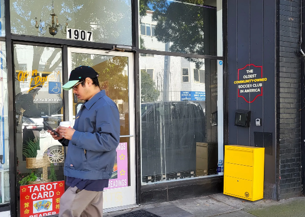Man in front of store.