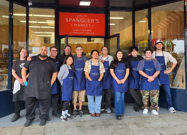 Workers pose for a photo.