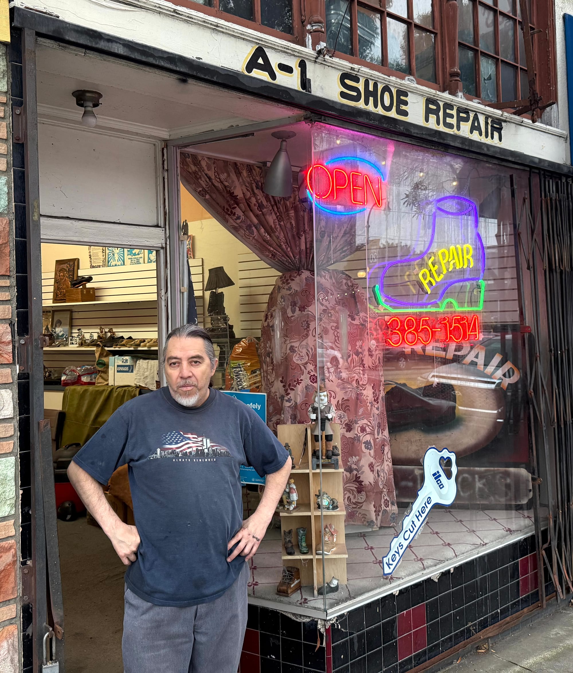 Man in front of storefront.