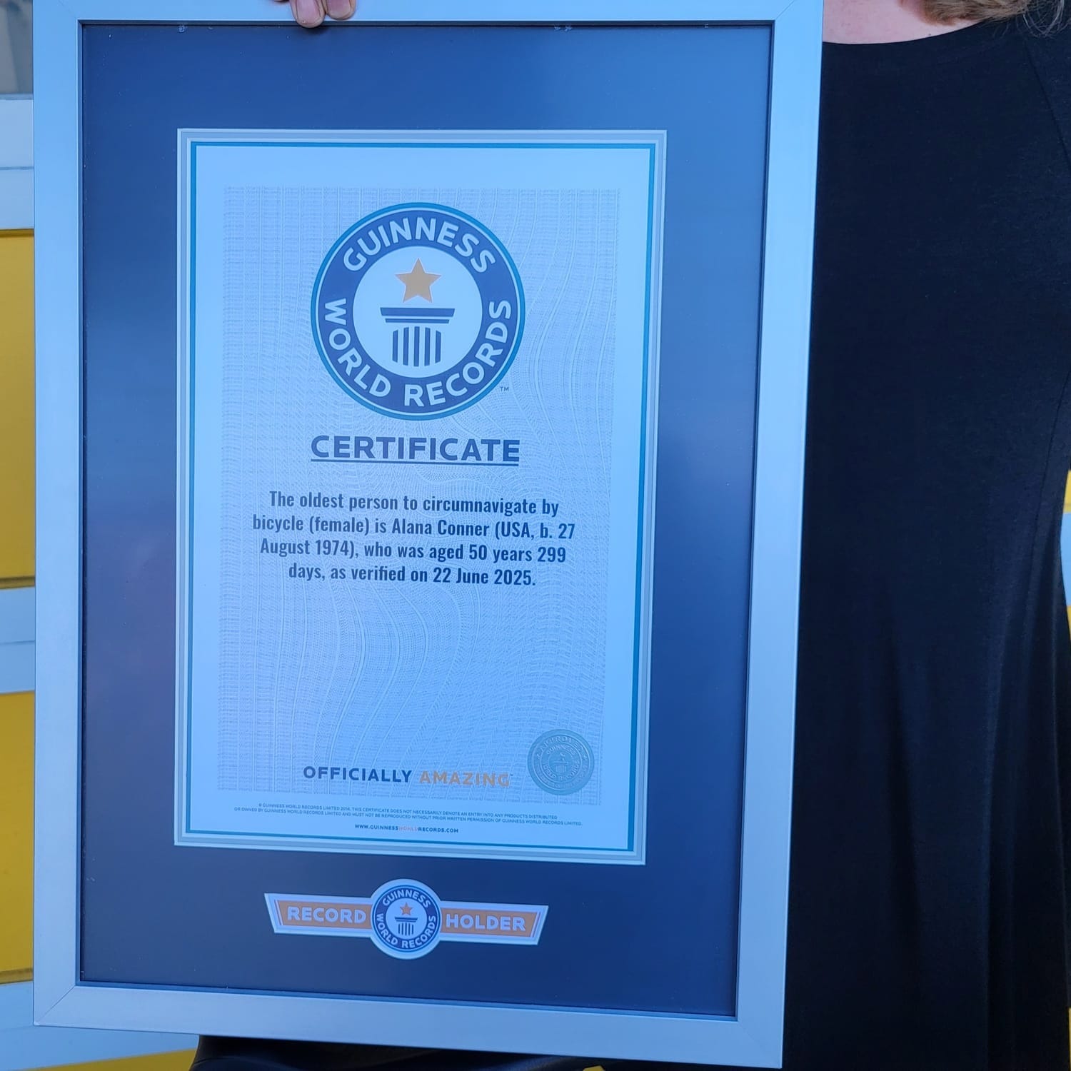 A woman holding a certificate.