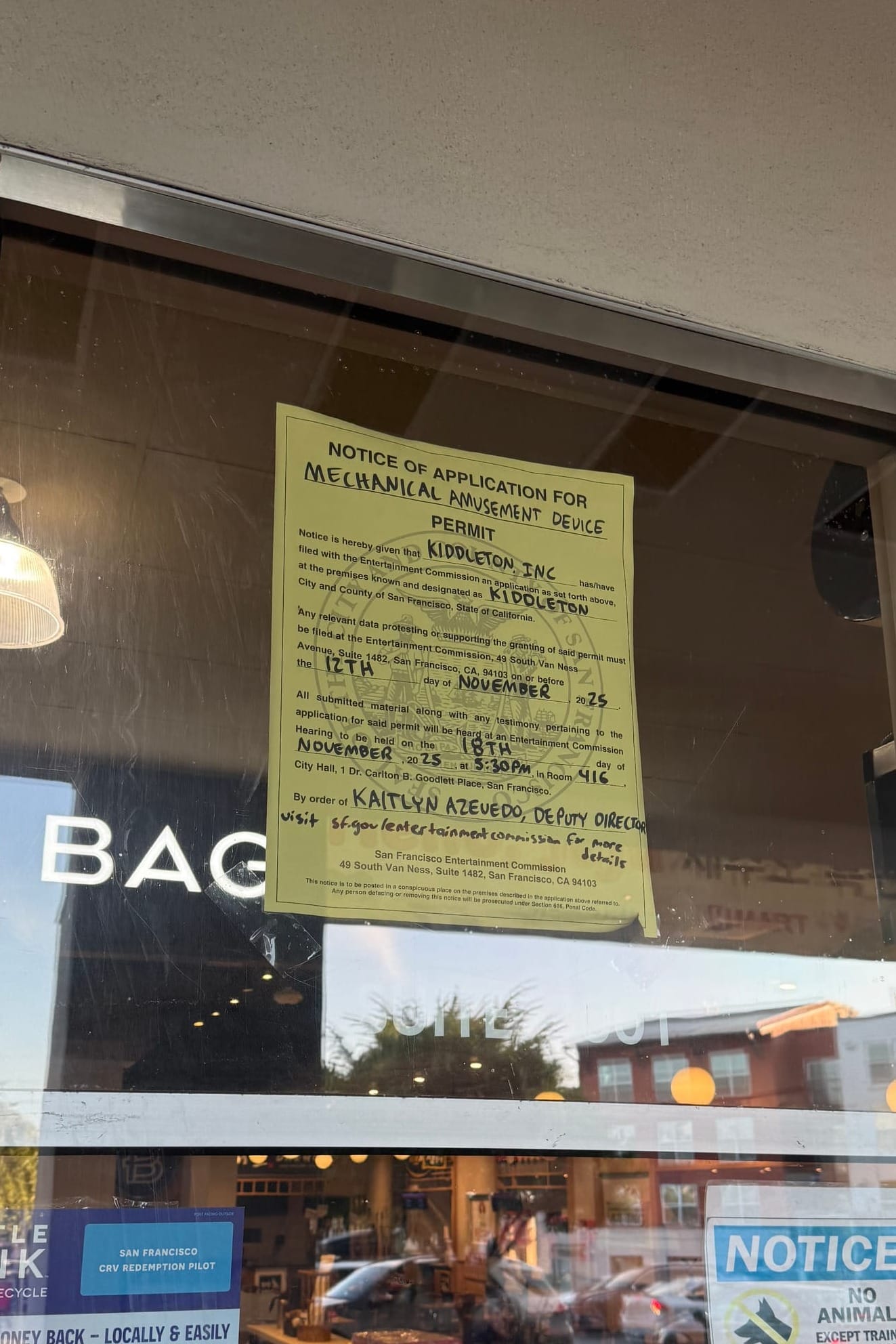 A sign in a grocery store window.