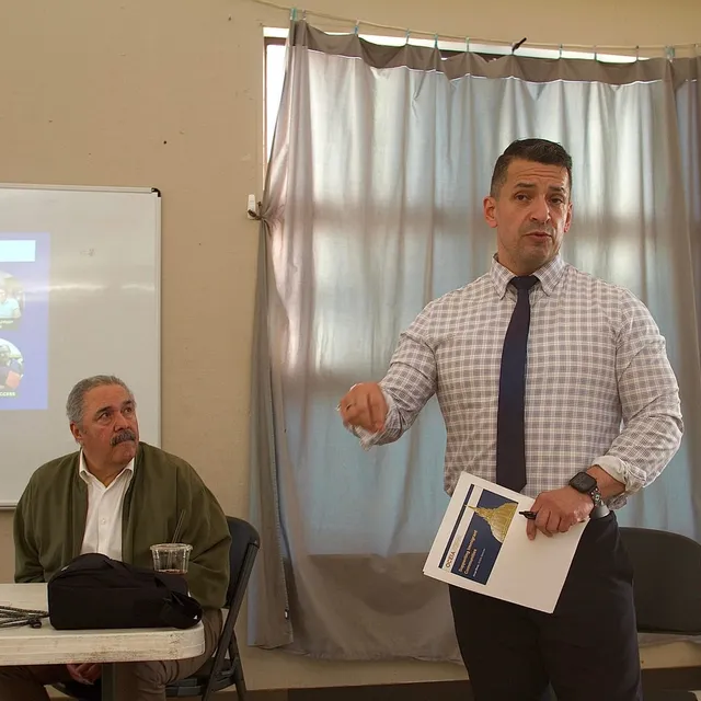 Man at meeting speaks.