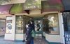 People walk in front of a storefront
