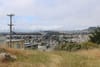 A view of open space in the foreground with homes in the distance.