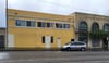 Building with vehicle parked in front.