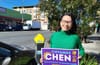 Woman standing on the street and holding sign that reads "Chyanne Chen for District 11 Supervisor."