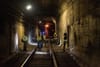 Workers inspect streetcar tunnel.