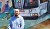 Man standing in front of a mural.