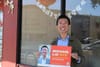 Man with campaign sign.