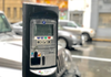 A parking meter with a car parked behind it.
