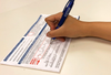 Person signing ballot.