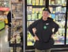 Woman posing for photograph in a grocery store.