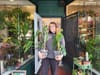 Person holding plants.