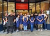 Grocery store workers gather for a photo.