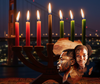 A Kinara with lit red, black and candles against a San Francisco cityscape backdrop with the Golden Gate Bridge and icon of Africa with a man and woman faces. 