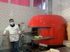 Man at pizza oven