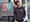Man stands for portrait in front of storefront.