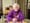 Woman seated at table.